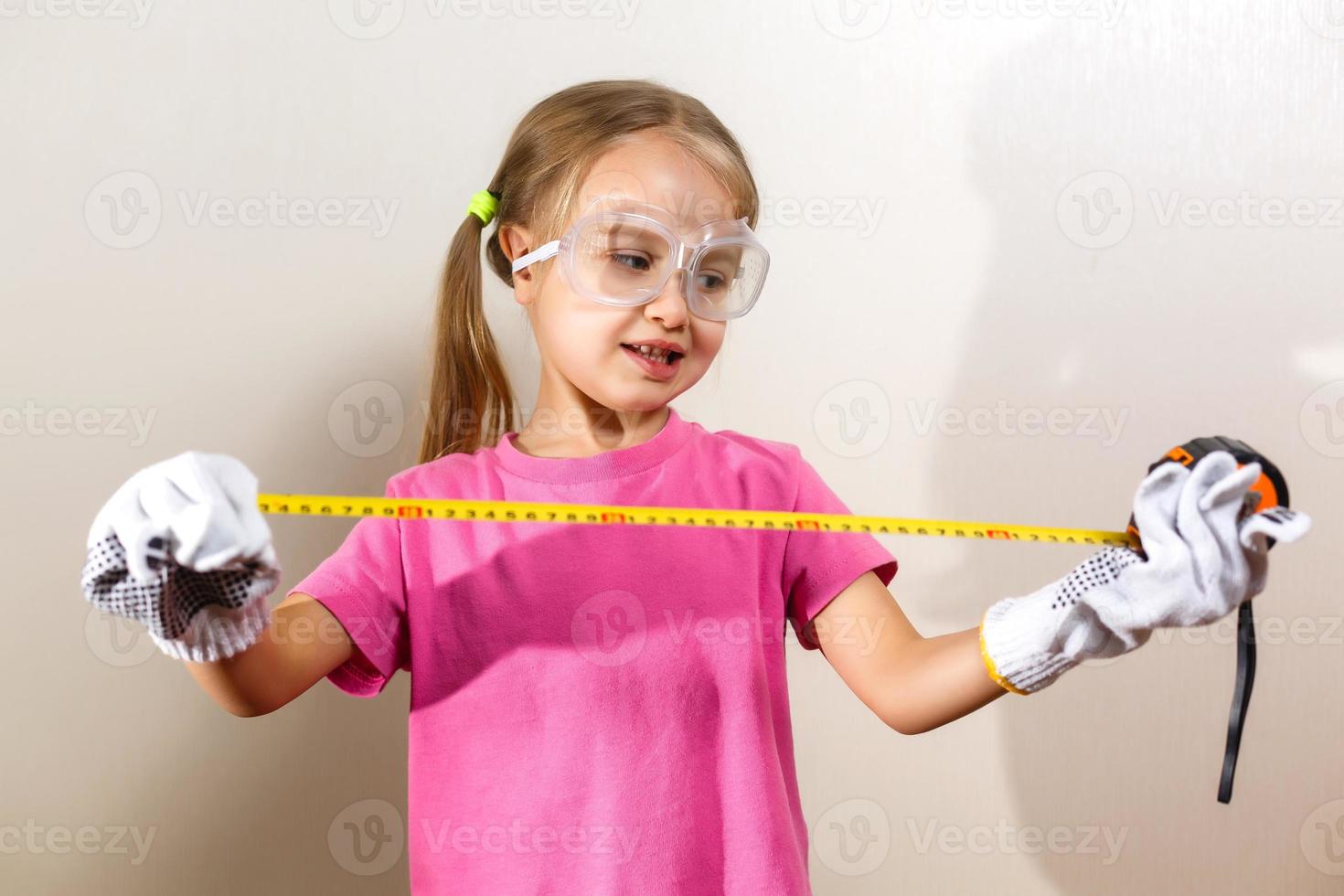 Little girl holding a meter isolated on white background the concept of development of the child photo
