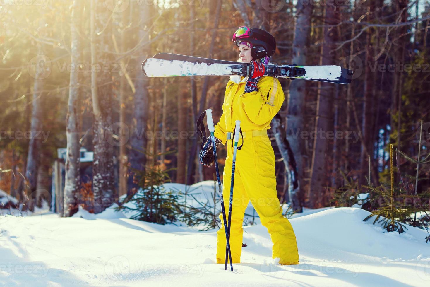 Panoramic shot of a female skier resting on top of the mountain observing nature at ski resort on a beautiful sunny winter day copyspace peaceful recreational vacation travel concept photo