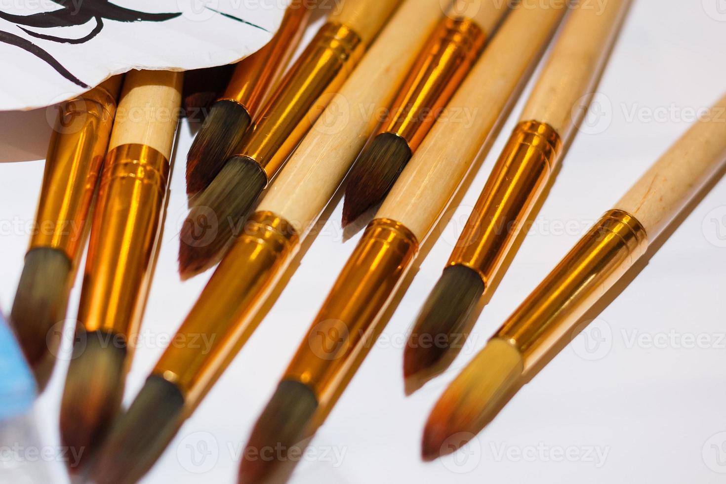 Set of brushes for painting pencils spatula in the bank against the backdrop photo