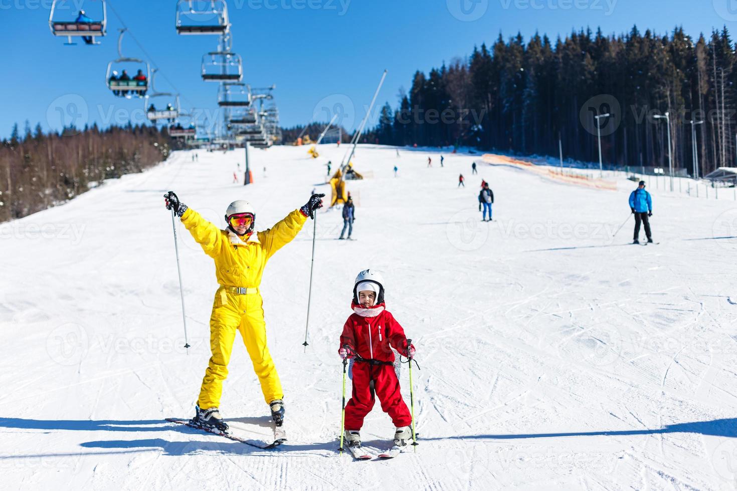 Skiing, winter, ski lesson, skiers on mountainside photo
