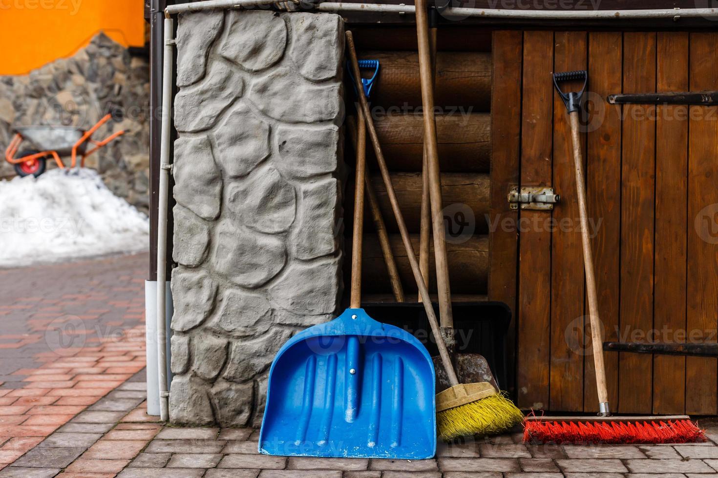 Snow removal equipment at the entrance to a cottage photo