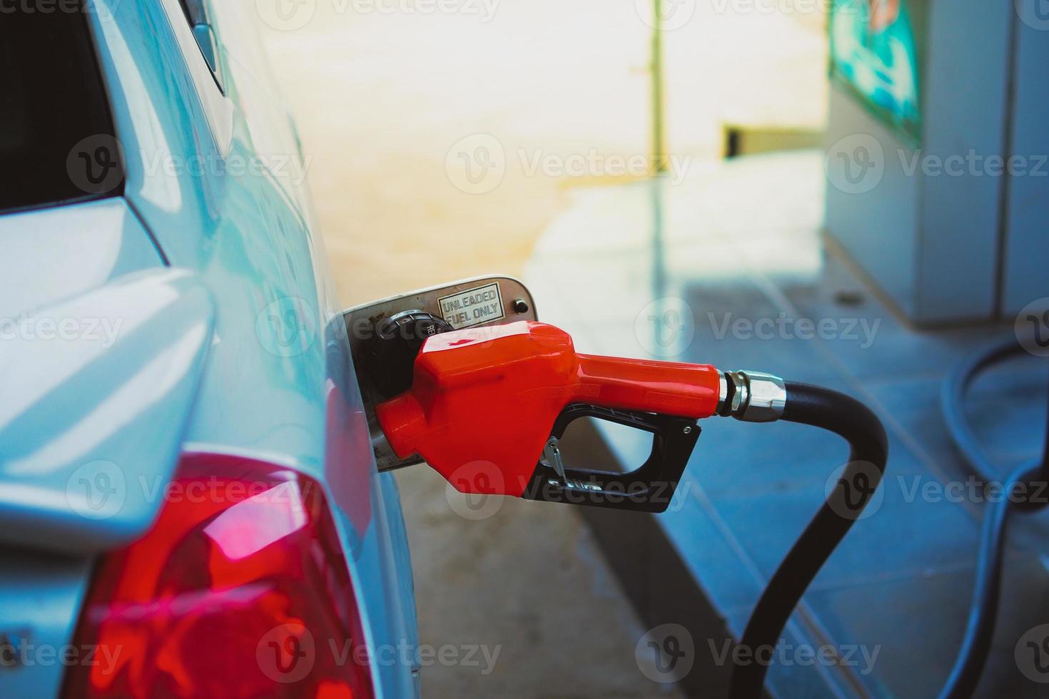 Gas station nozzles. Cars that are refueling in the gas station. The concept of fuel prices has changed. photo
