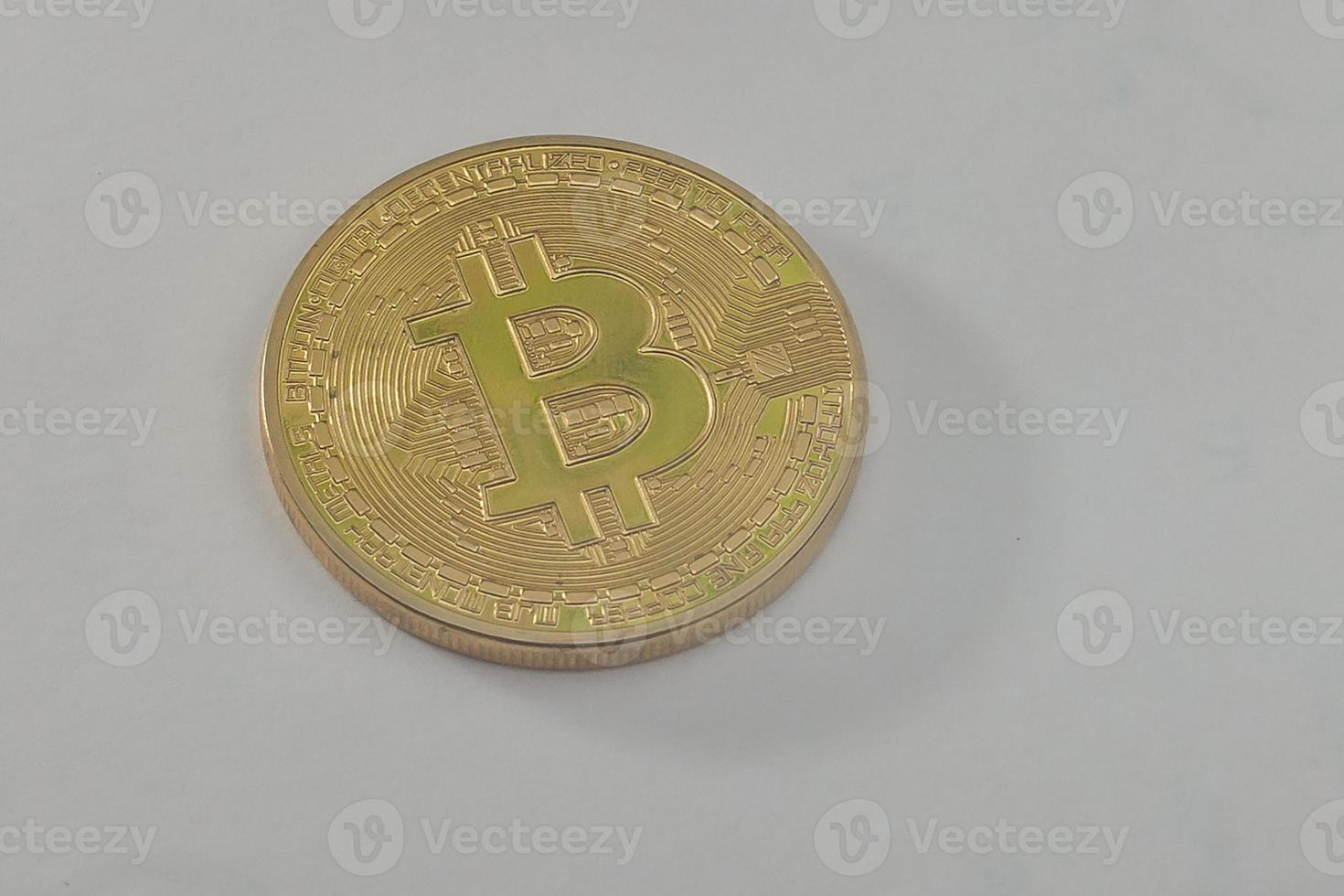 Gold coin of bitcoin on a gray background photo
