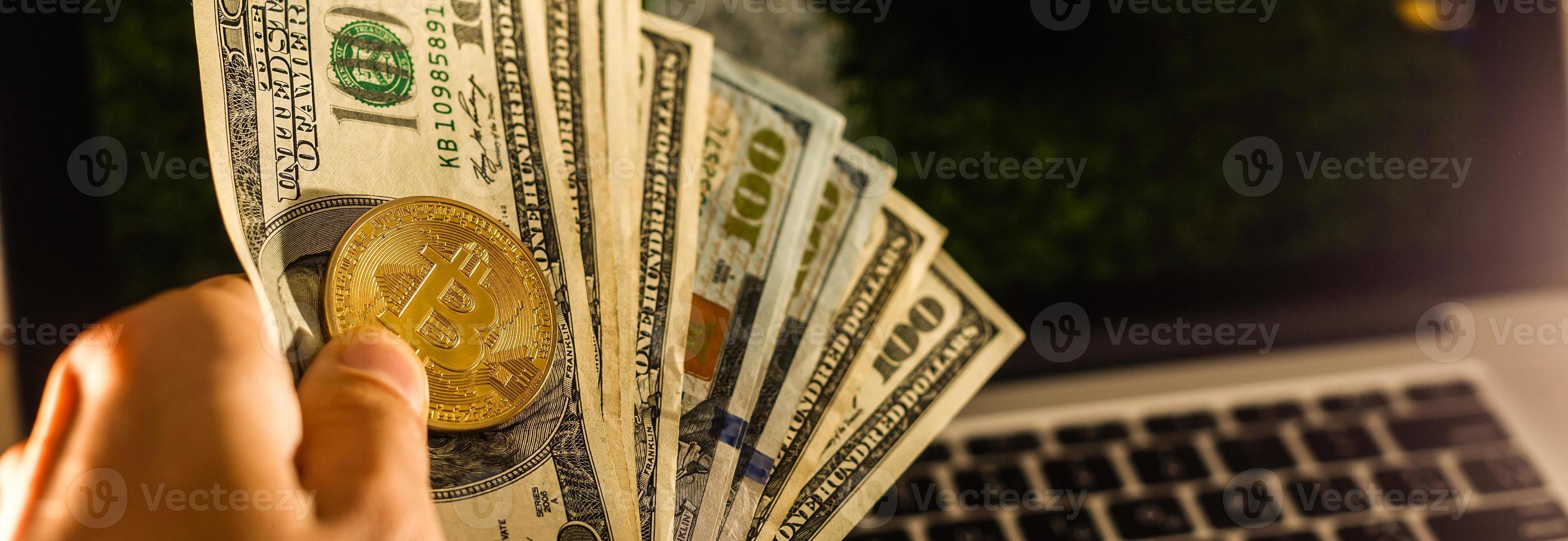 Golden Bitcoins on US dollars. Digital currency close-up. New virtual money. Crypto currency top view. Real coins of bitcoin on banknotes of one hundred dollars. Exchange. Bussiness, commercial. photo