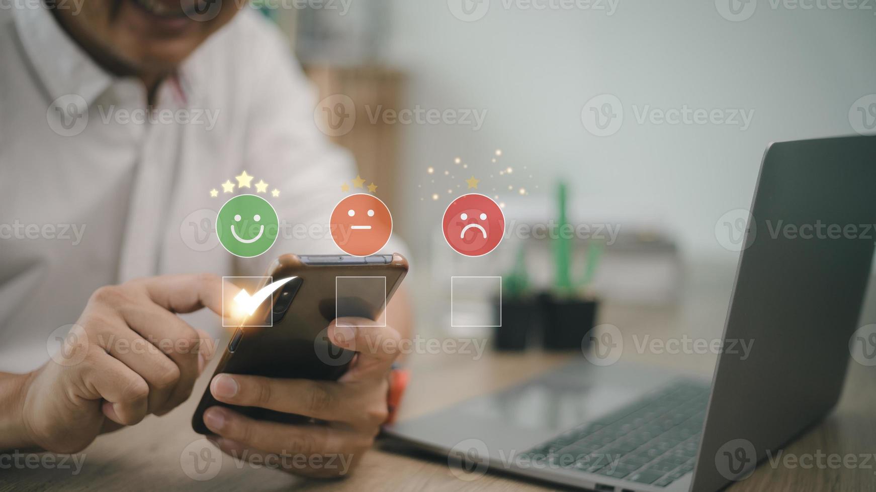 man use smartphone choosing green happy smile face icon. feedback rating and positive customer review experience, satisfaction survey. mental health assessment. world mental health day concept photo