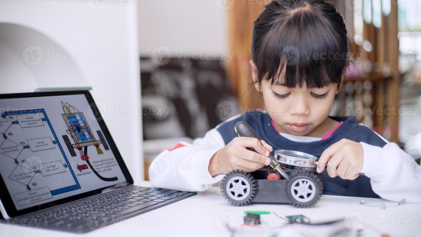 Asia students learn at home in coding robot cars and electronic board cables in STEM, STEAM, mathematics engineering science technology computer code in robotics for kids concept photo