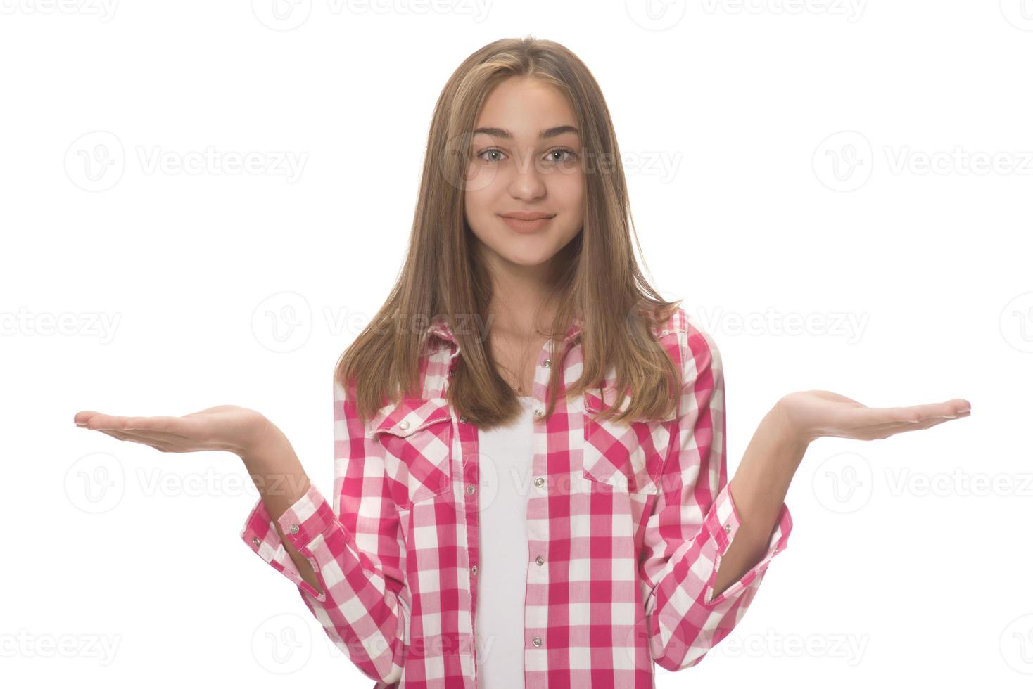 young beautiful woman in gray shirt , holding imaginary object on the palm. isolated on white photo