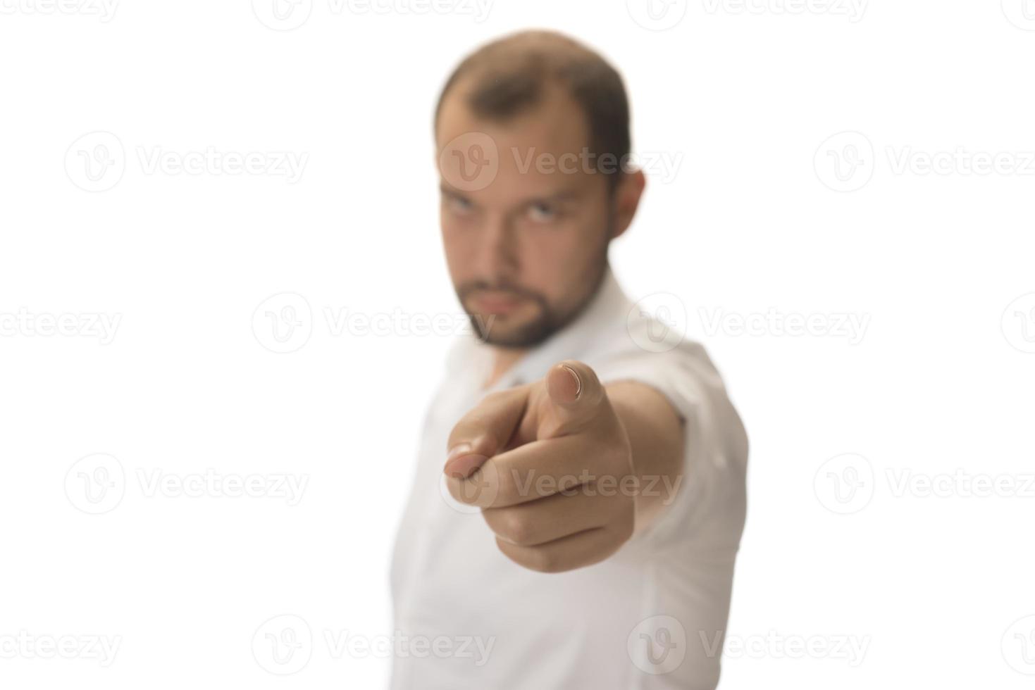 Portrait of young man pointing forward, looking at camera. Choosing someone concept photo