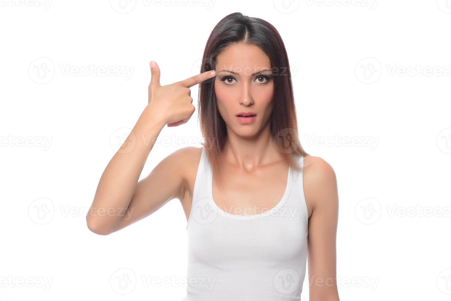 funny beautiful Arabic female model  wearing white sport set over white background crosses eyes and makes fish lips funny grimace posing on white background photo