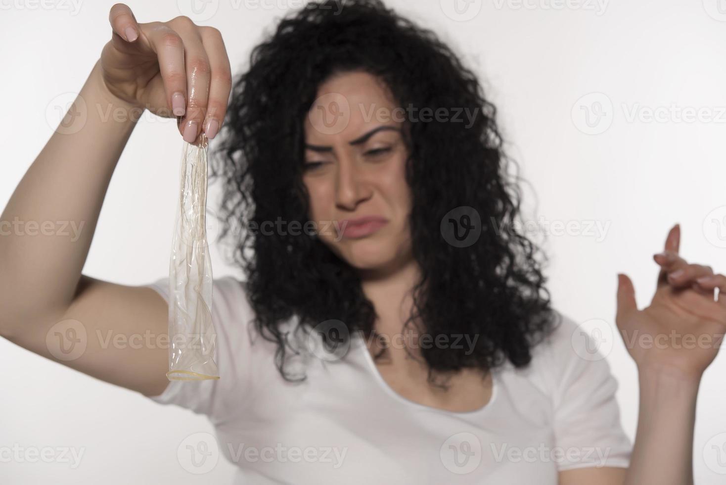woman holding condom. save sex concept. isolated photo