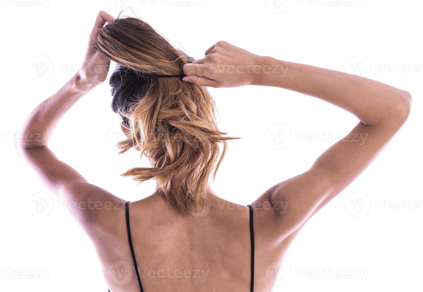 emale holding messy damaged dry hair in hands. photo
