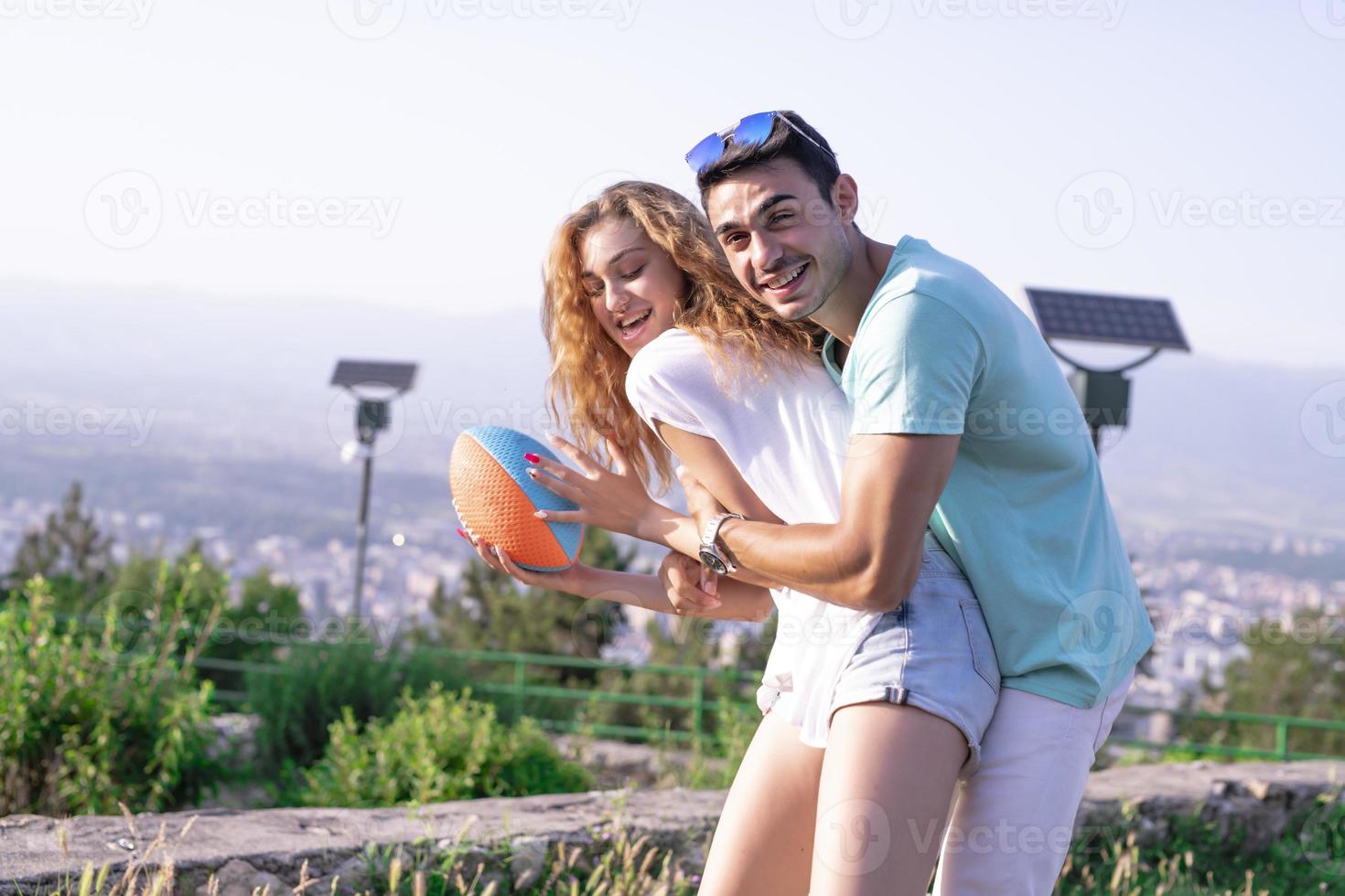 Couple playing American football on hot summer day. Couple playing Rugby photo shoot