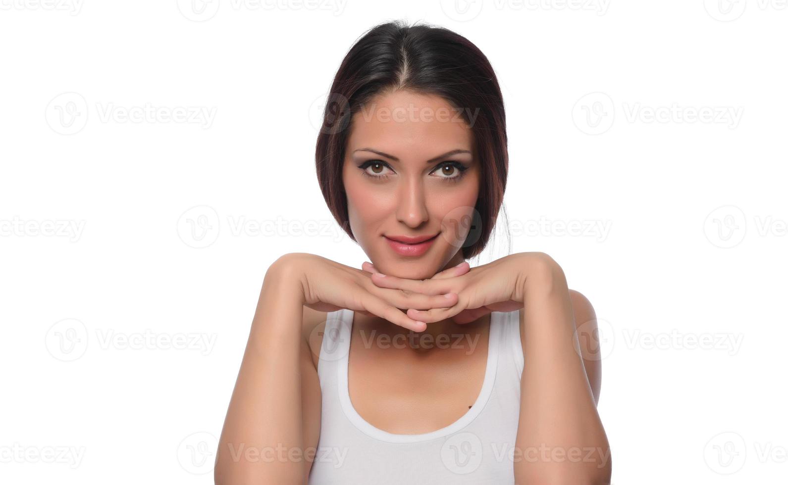 funny beautiful Arabic female model  wearing white sport set over white background crosses eyes and makes fish lips funny grimace posing on white background photo