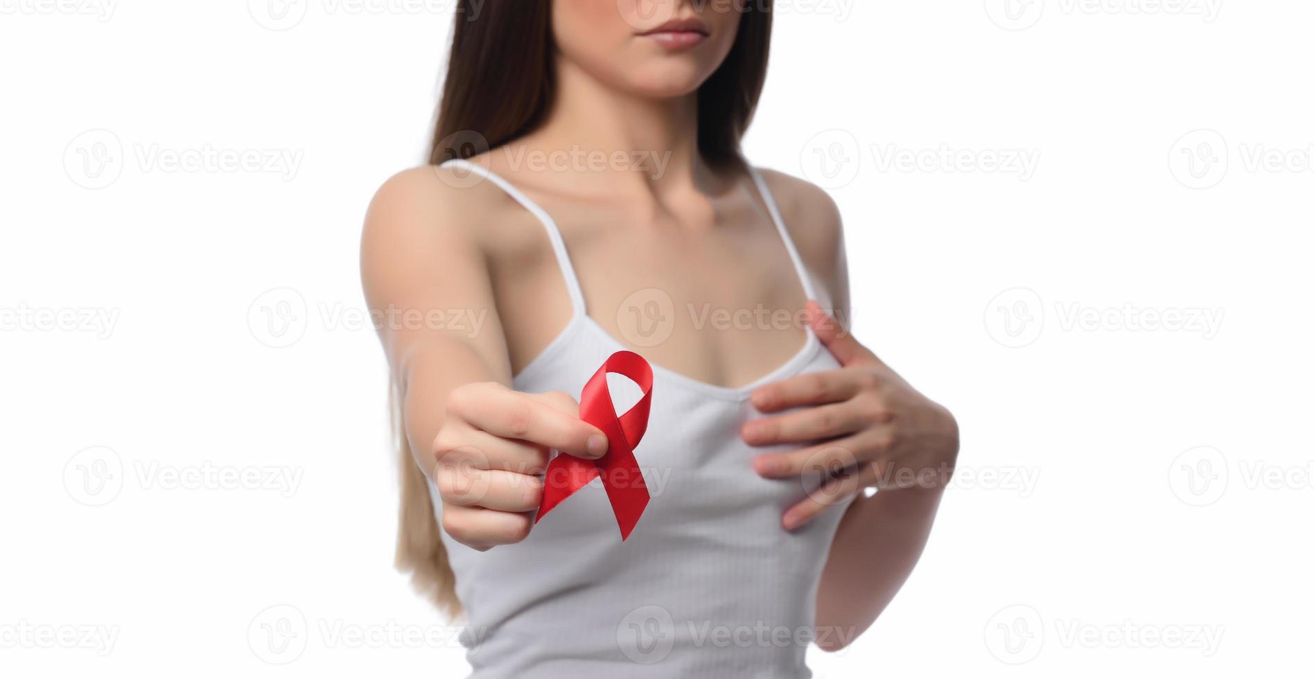 Woman holding red ribbon for December world aids day. Healthcare concept photo