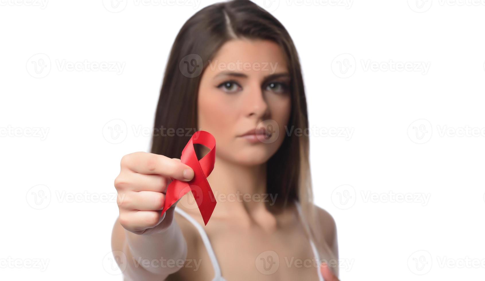 Woman holding red ribbon for December world aids day. Healthcare concept photo