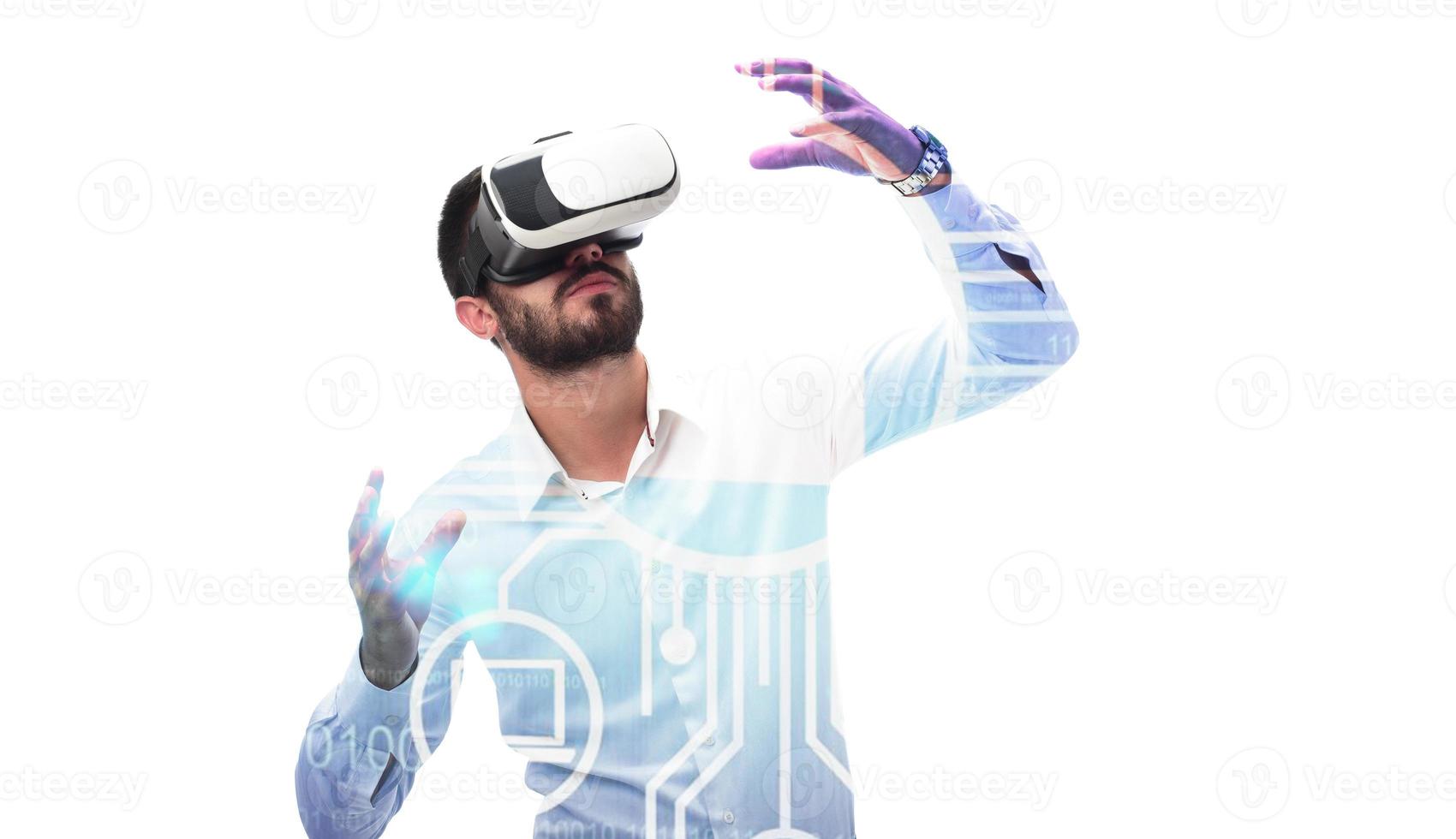 man in vr glasses, playing video games with virtual reality headset, trying to touch something with hand photo