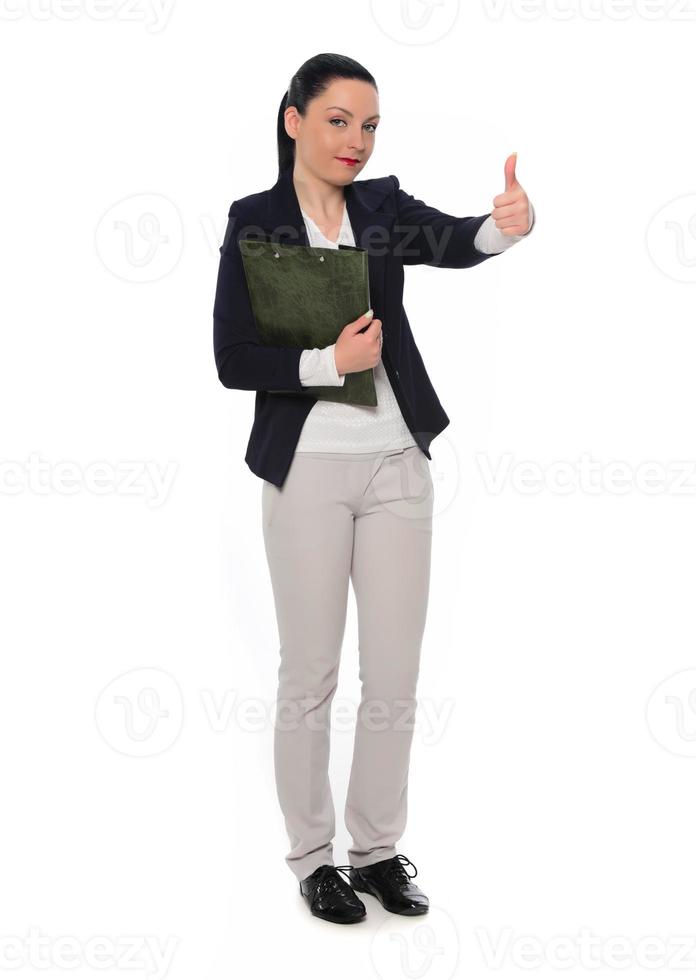Happy  business woman showing thumb up and looking at the camera over gray background photo