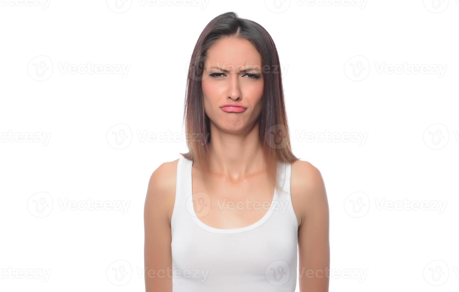 funny beautiful Arabic female model  wearing white sport set over white background crosses eyes and makes fish lips funny grimace posing on white background photo