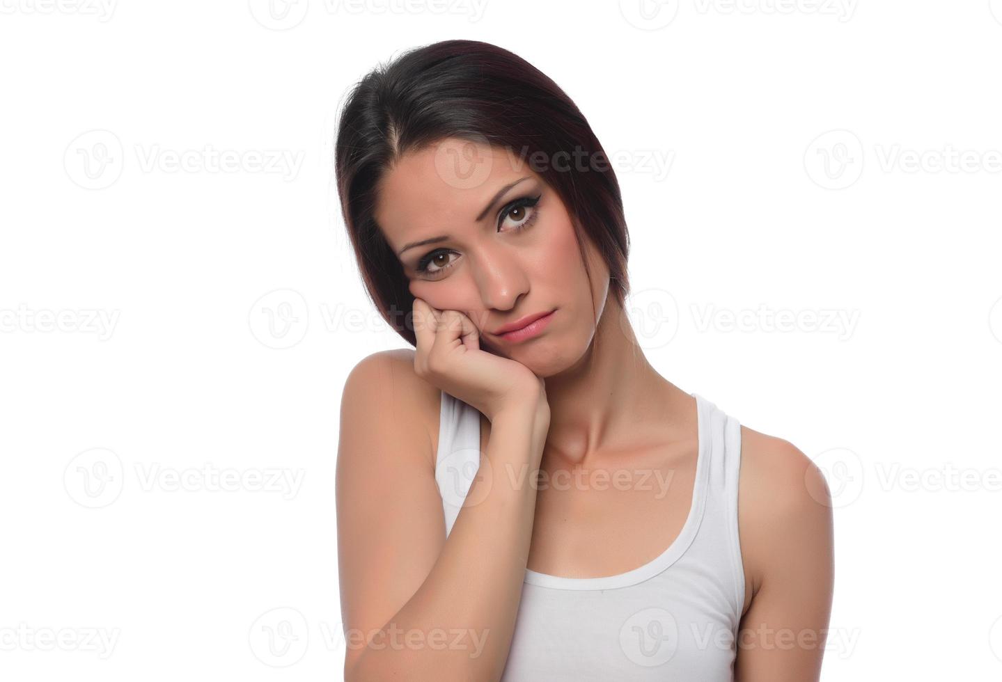 funny beautiful Arabic female model  wearing white sport set over white background crosses eyes and makes fish lips funny grimace posing on white background photo