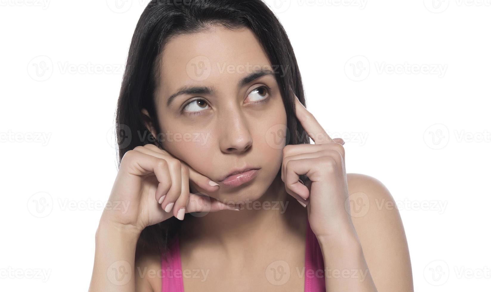 What, say louder, cannot hear you. Confused intense and annoyed woman in pink t-shirt, gesturing palm cluelessly, holding hand near ear photo