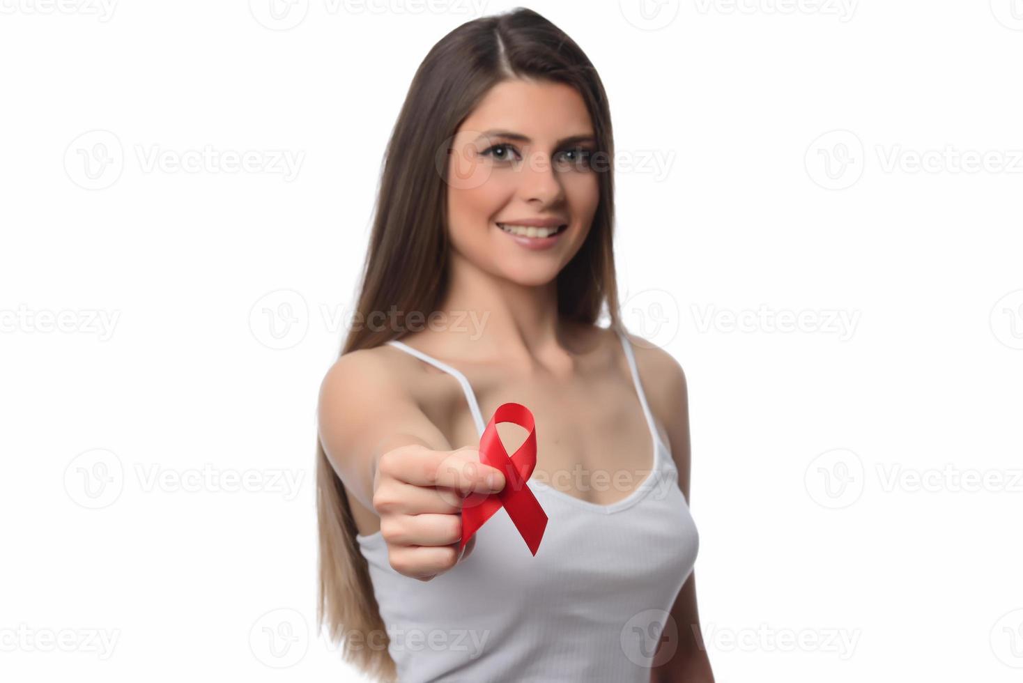 Woman holding red ribbon for december world aids day. Healthcare concept photo