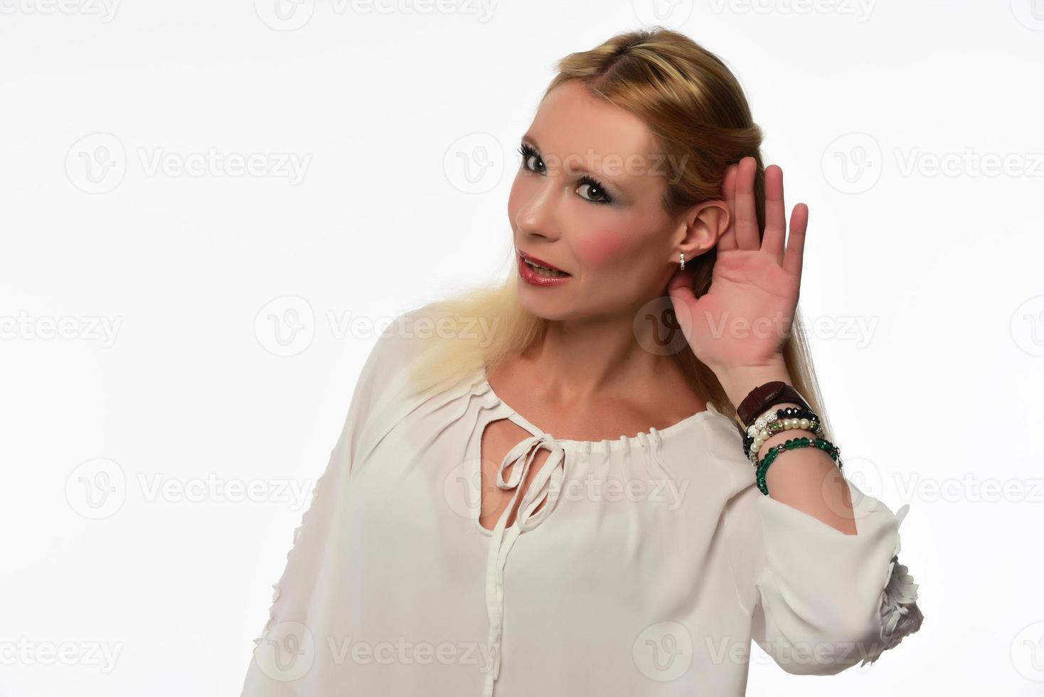 Female making can't hear you gesture isolated on white background photo
