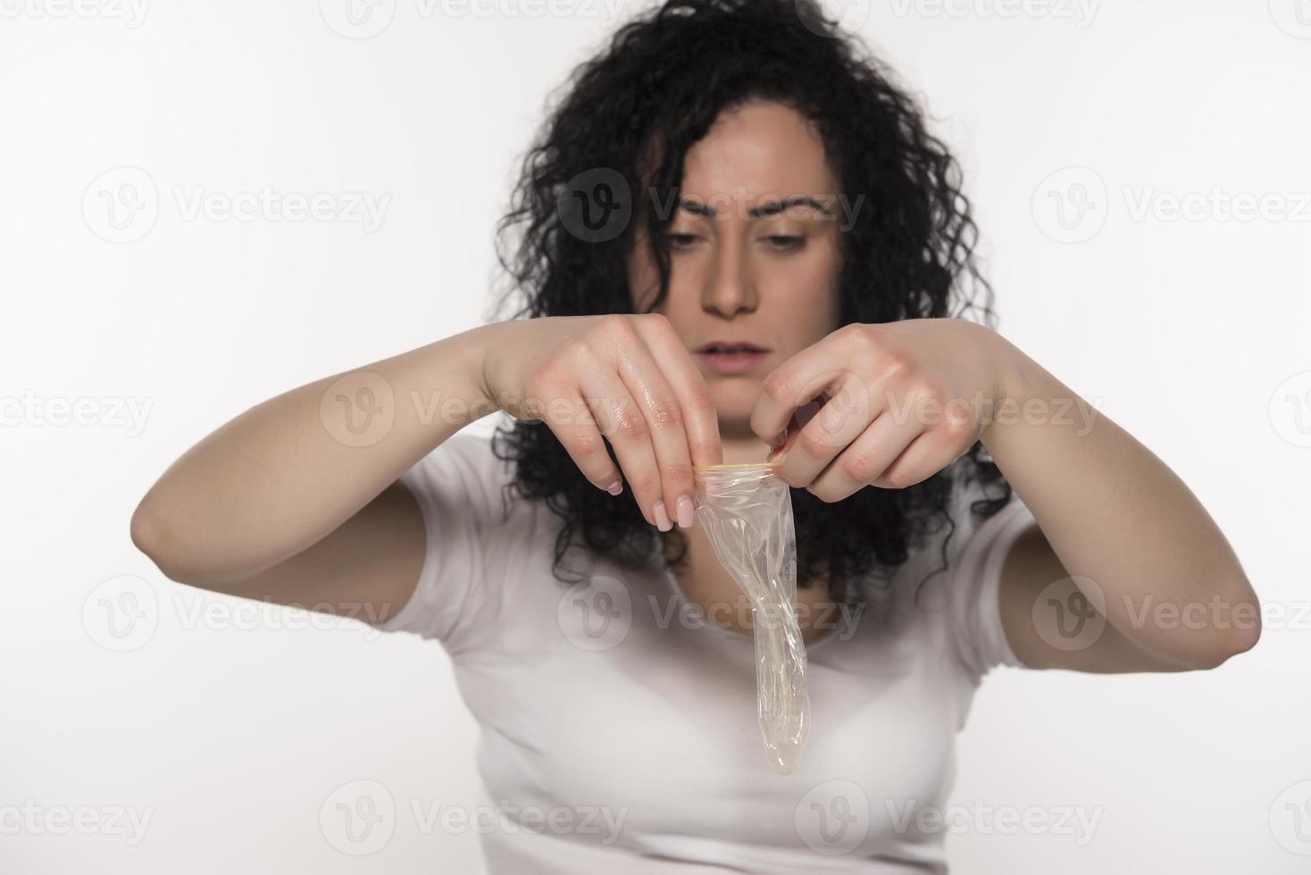 woman holding condom. save sex concept. isolated photo