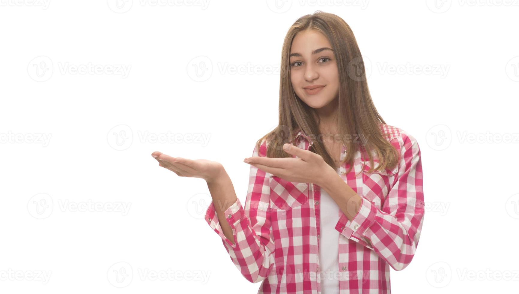 young beautiful woman in gray shirt , holding imaginary object on the palm. isolated on white photo