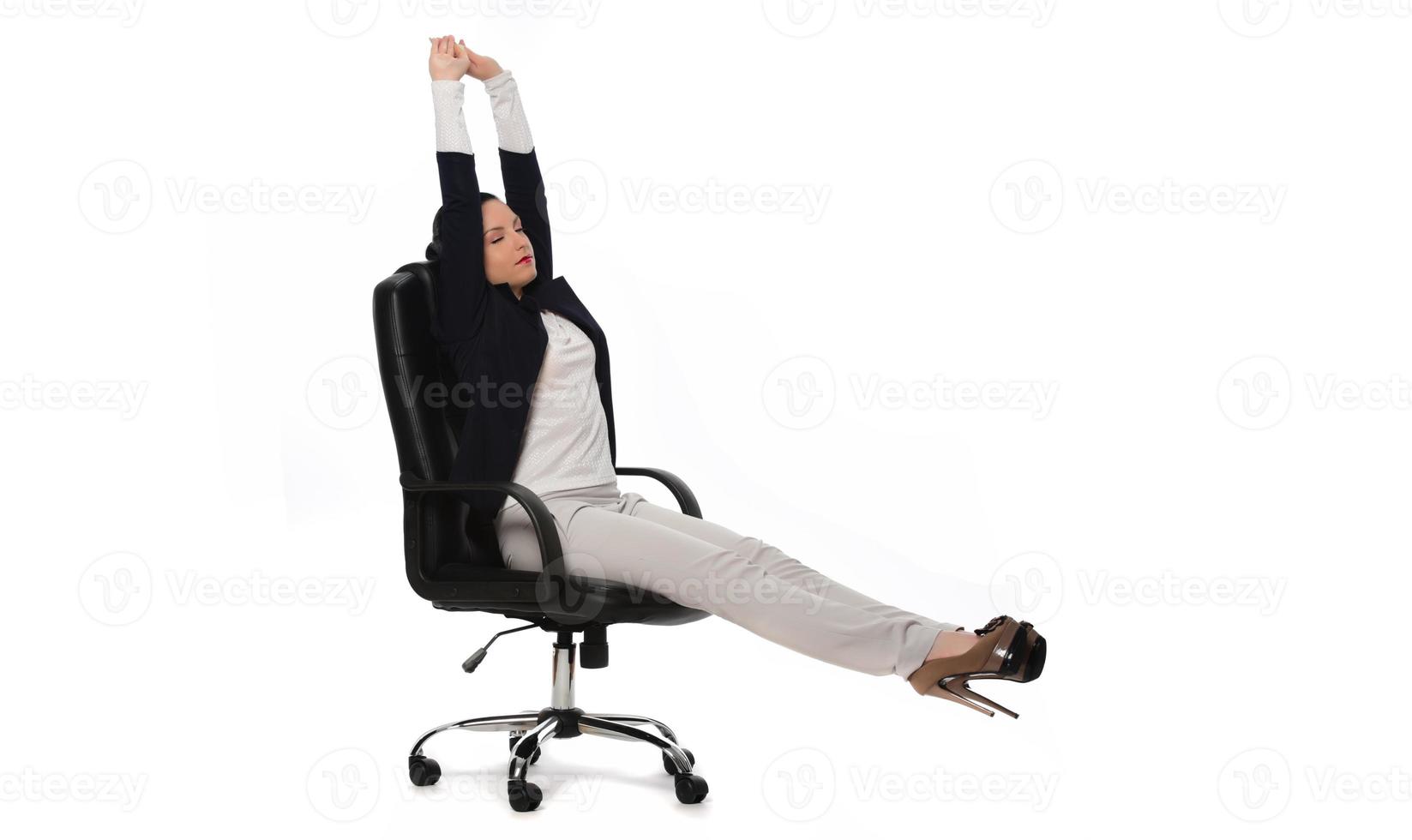 Young businesswoman sitting in comfortable office chair on white background photo