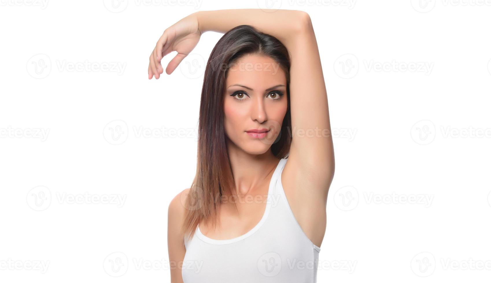 funny beautiful Arabic female model  wearing white sport set over white background crosses eyes and makes fish lips funny grimace posing on white background photo