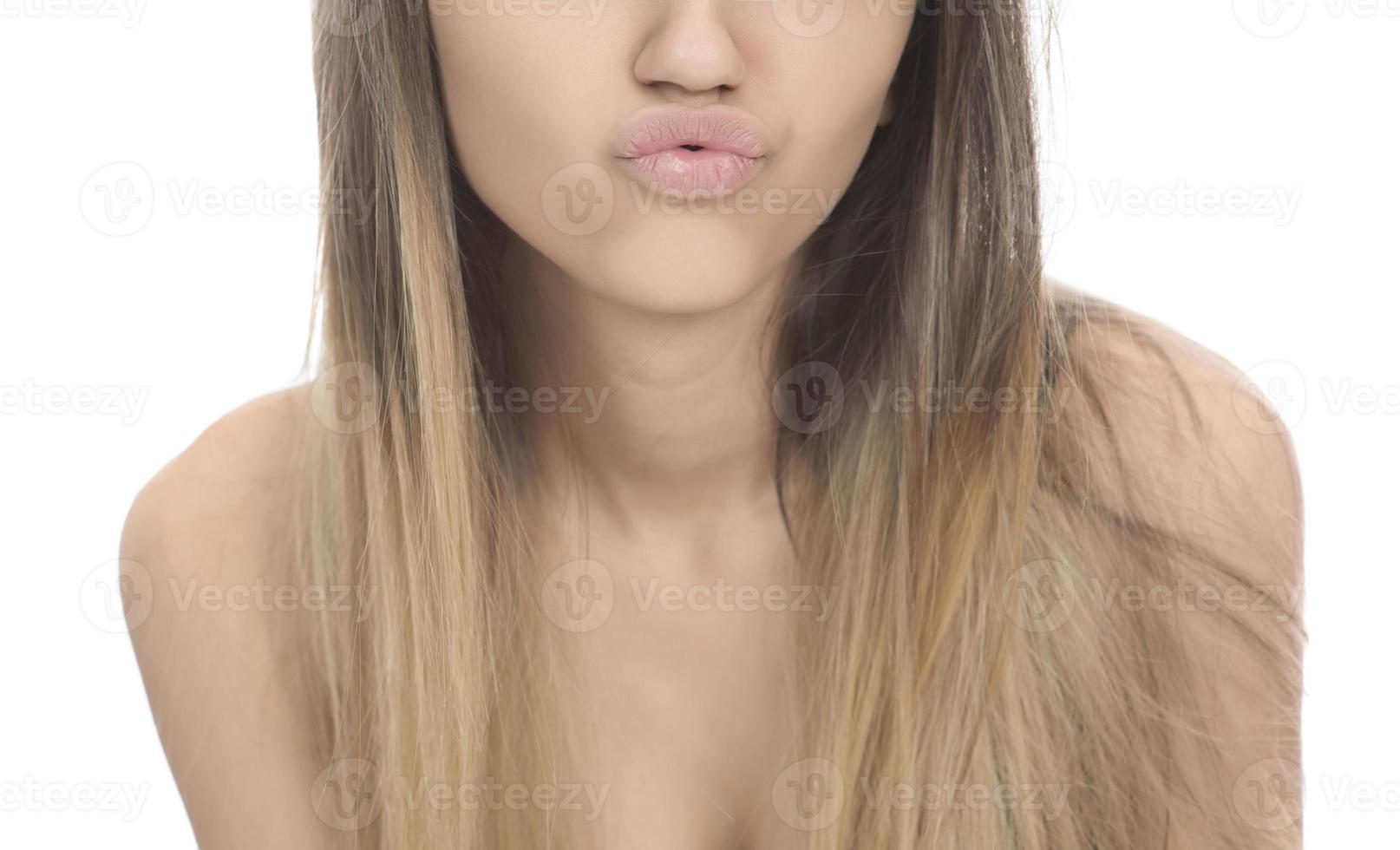 funny female model over white background crosses eyes and makes fish lips funny grimace photo