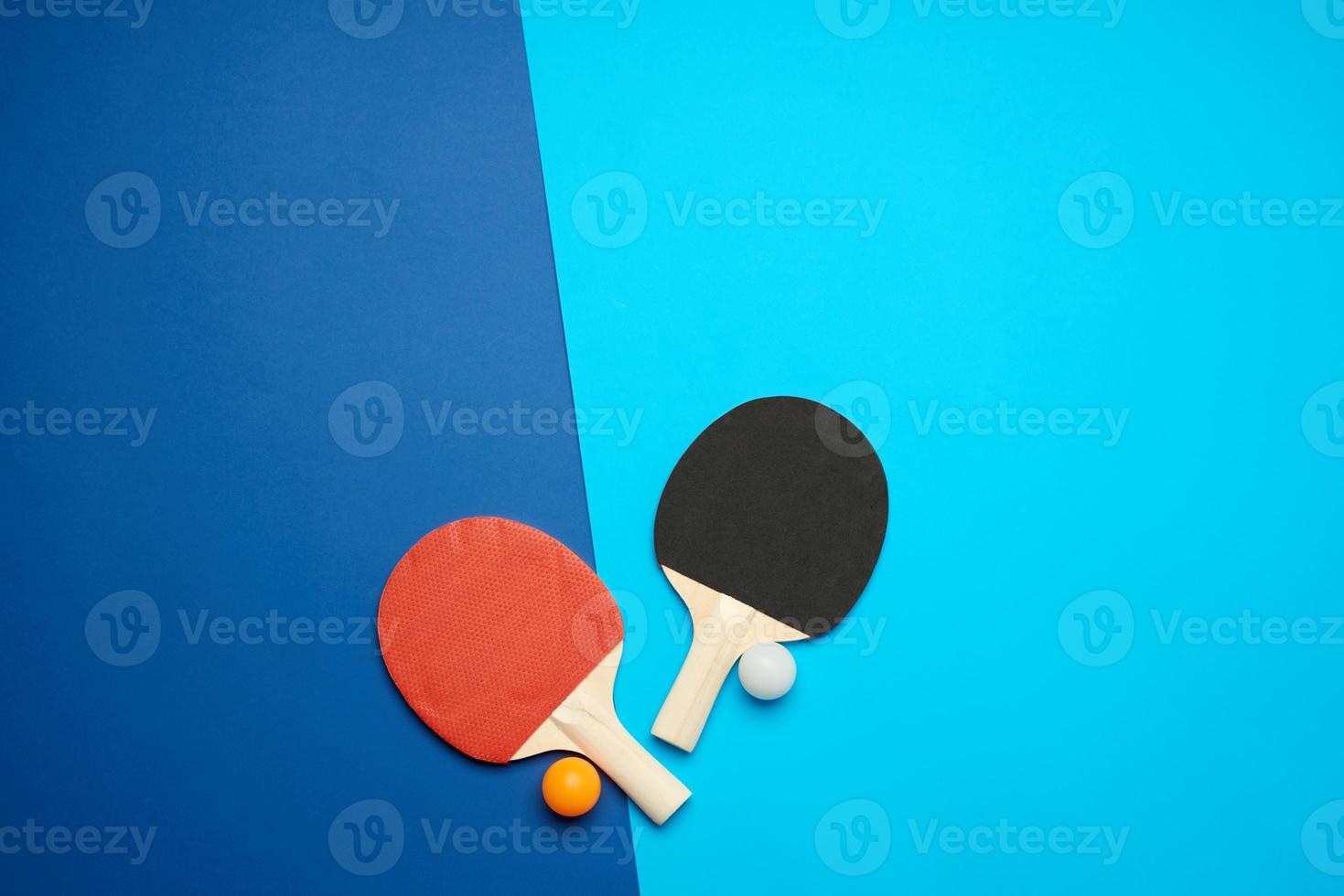 wooden rackets for playing table tennis and a net on a blue background photo