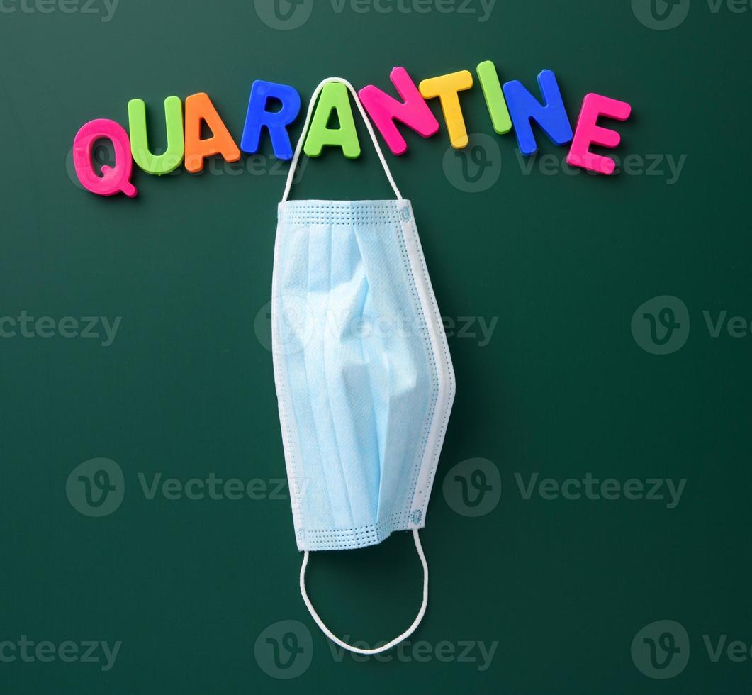 inscription quarantine from multi-colored plastic letter on a green chalk board photo