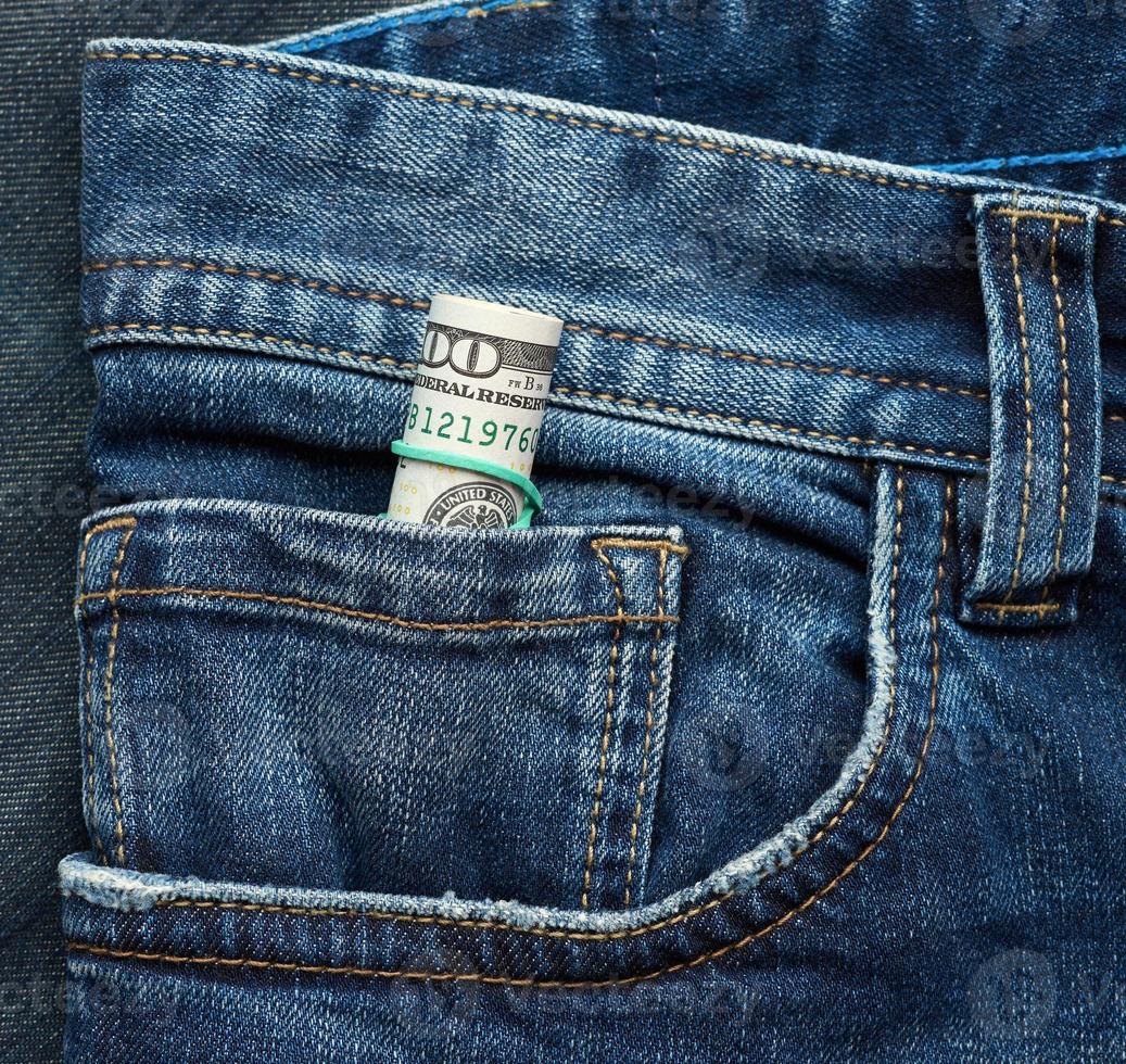 rolled up paper hundred dollar bills and tightened with green rubber band photo