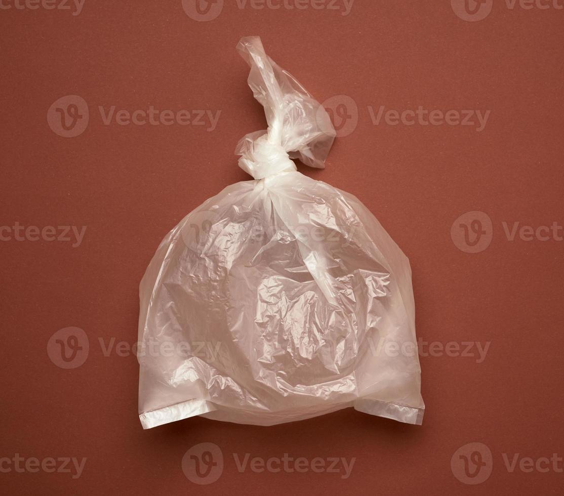 blank transparent plastic bag on brown background photo