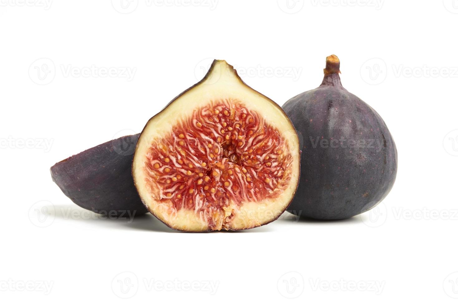 ripe whole and halved purple figs isolated on white background photo