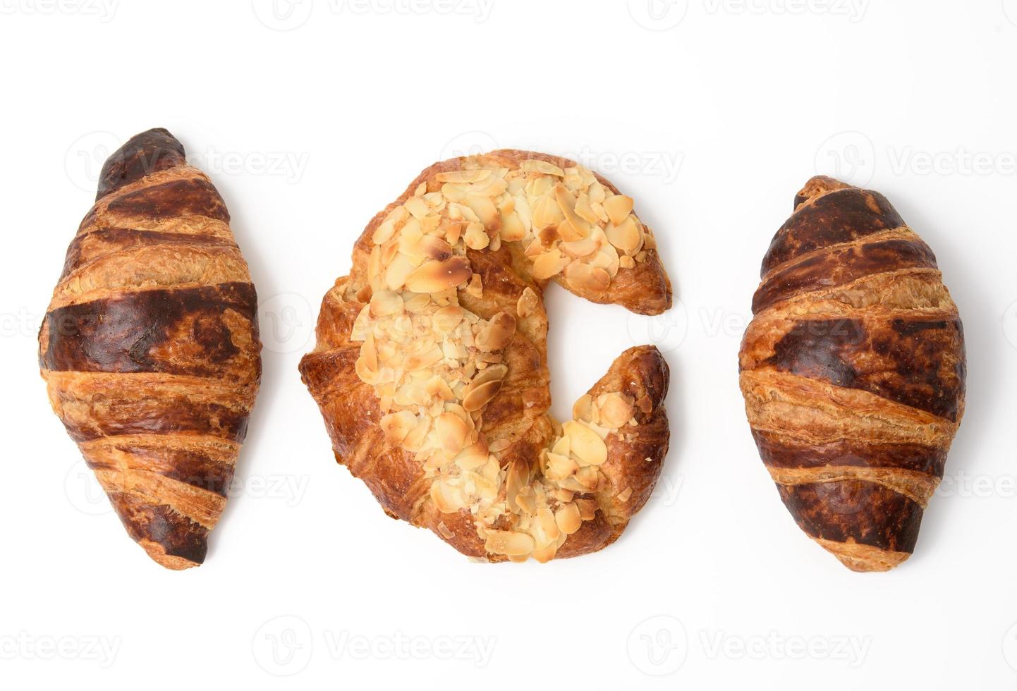 baked croissant sprinkled with almonds, dessert isolated on white background, set photo