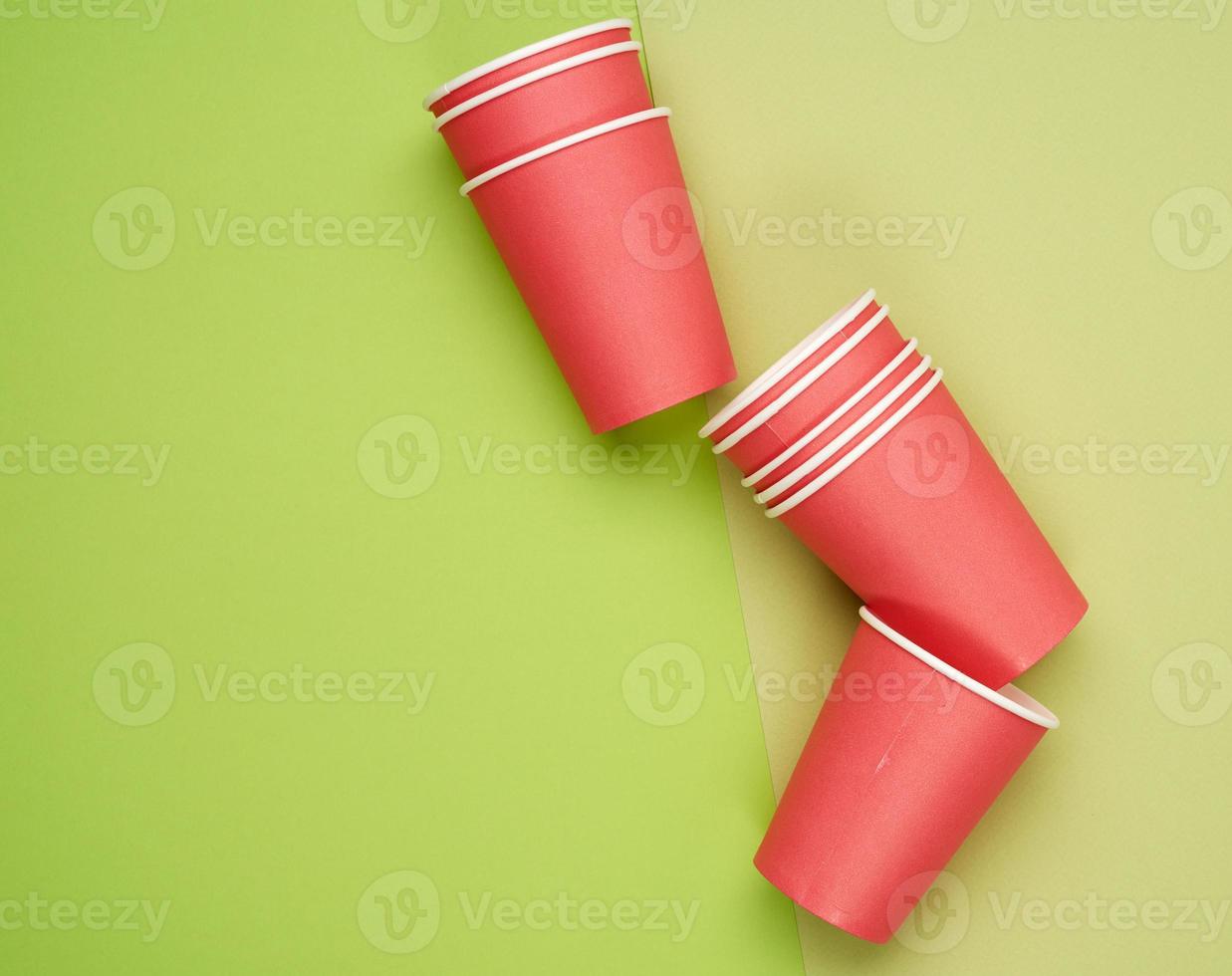 stack of red paper disposable cups on a blue background, flat lay, concept eco-friendly photo