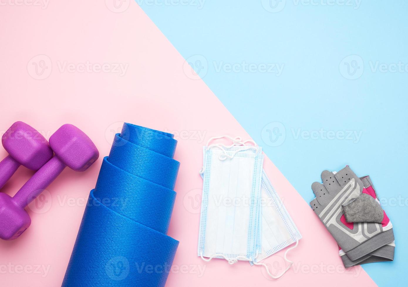 pair gloves, blue neoprene mat,  medical face mask and a pair of dumbbells photo