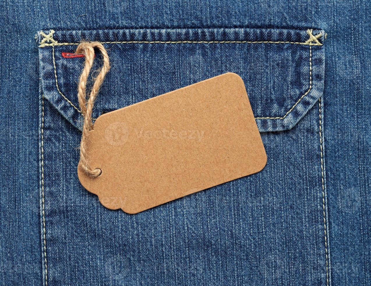 empty brown paper tag on a rope tied to blue jeans photo