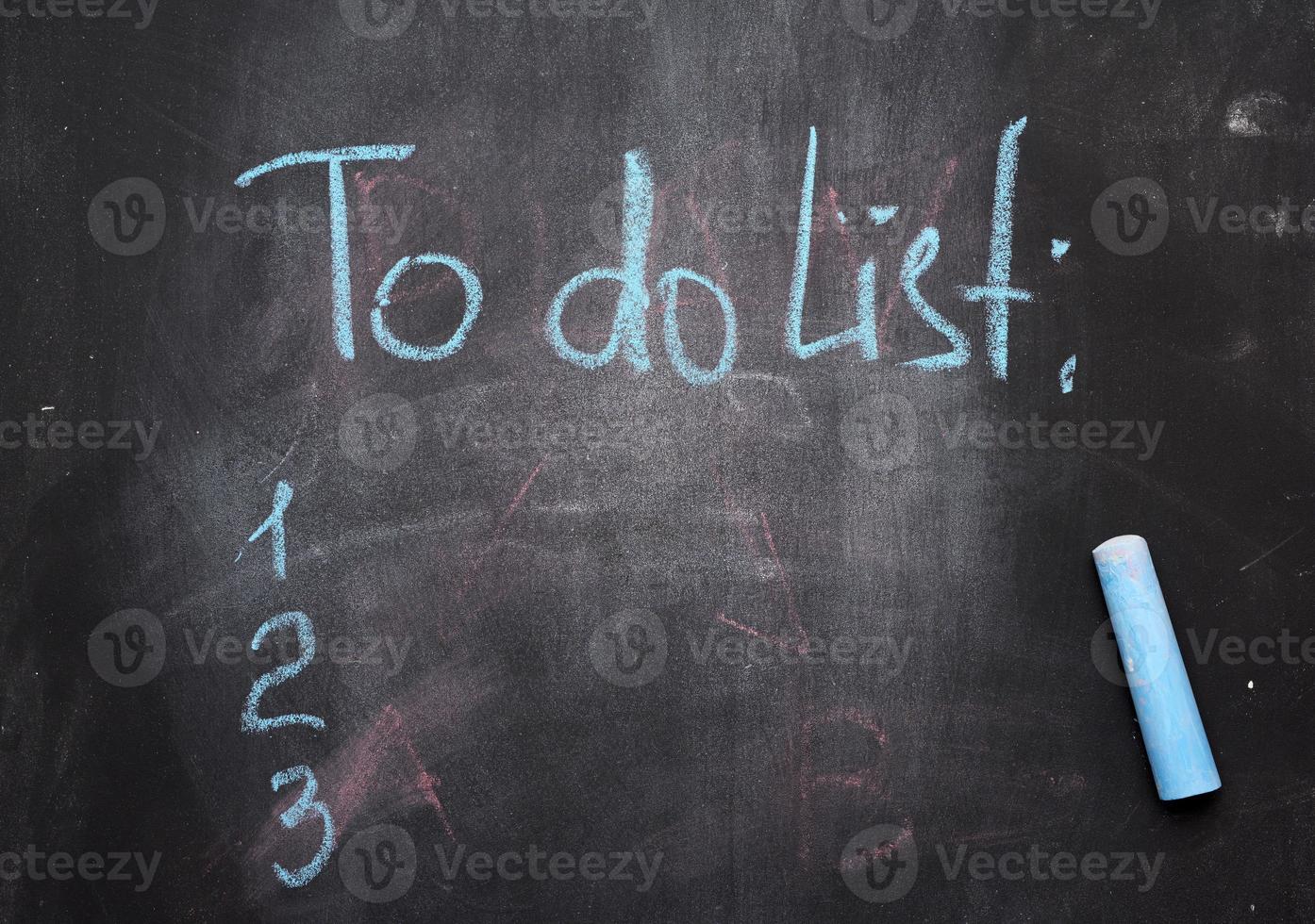 inscription to do list on a black chalk board and blue chalk photo