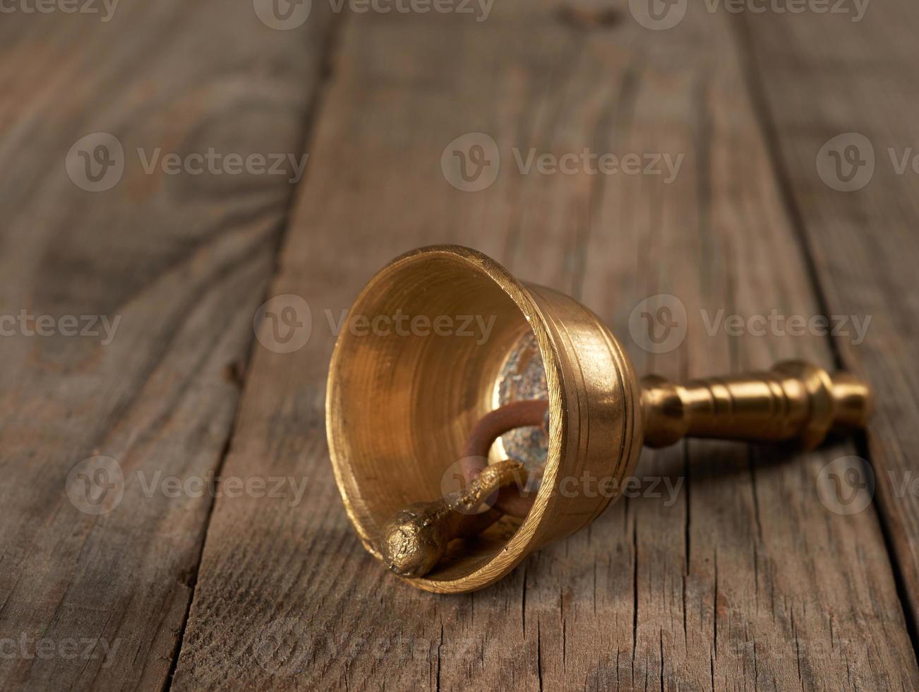 bronze bell for alternative medicine on a wooden background photo