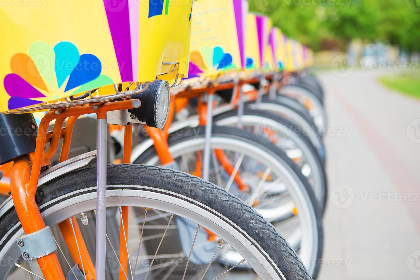 A number of beautiful bicycles are rented on street photo