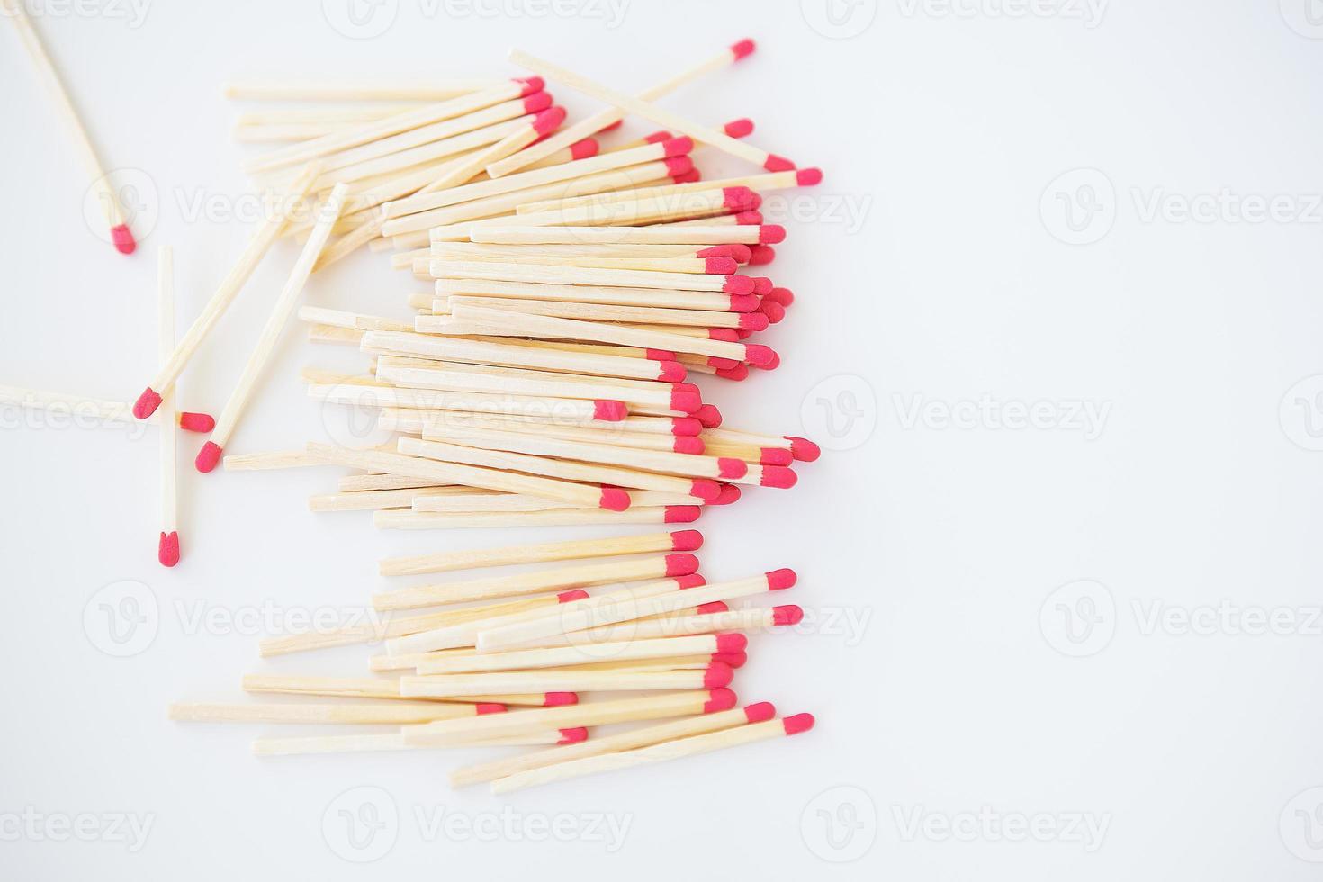 Long matches with a red head on a white background. photo