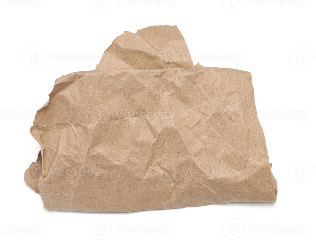 piece of crumpled brown paper isolated on white background photo