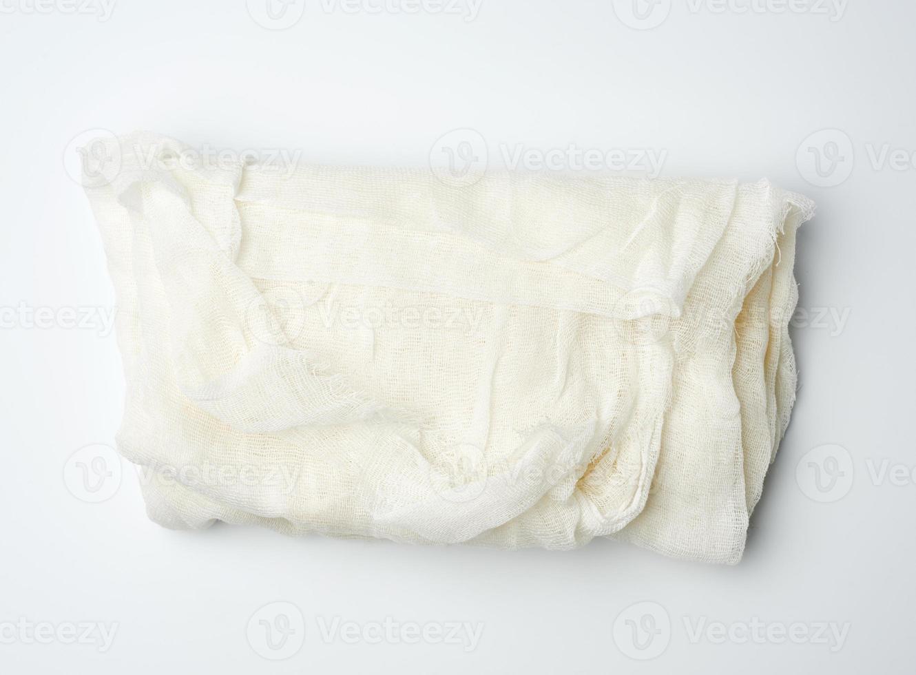 folded cotton white gauze fabric on a white background photo