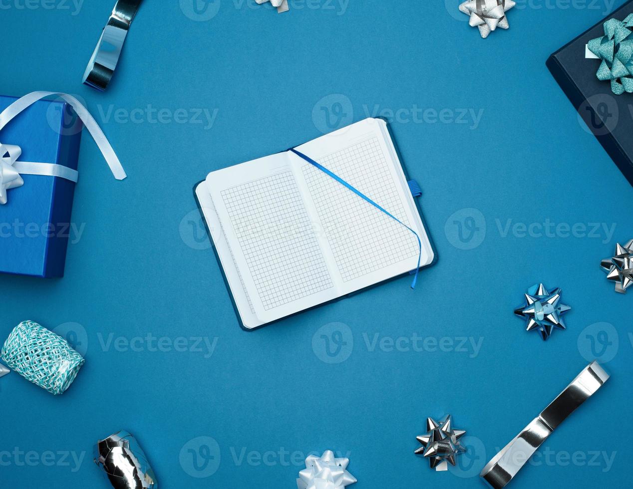 open notebook with empty white sheets, blue background with box photo