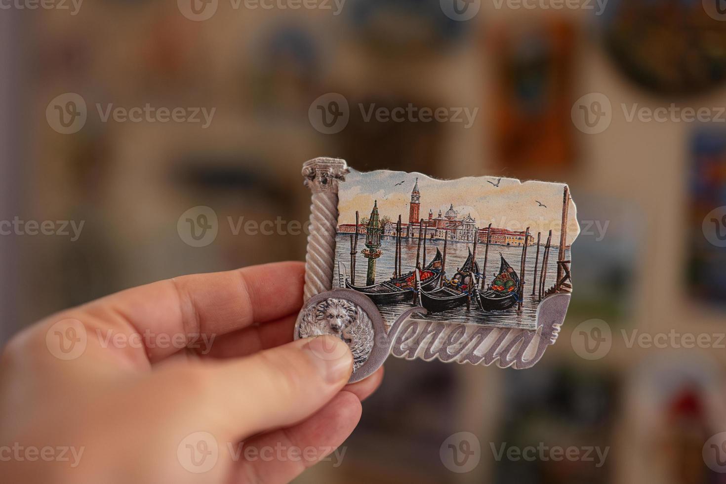 Venice Italy souvenir refrigerator magnet at hand. photo