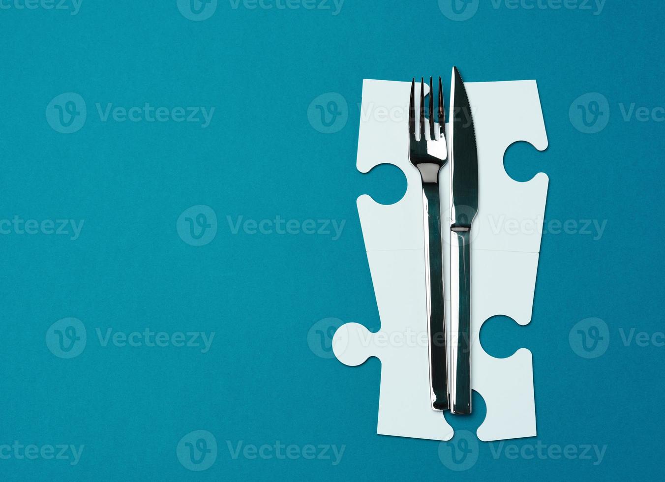 fork with knife on a blue background, top view. Table setting photo