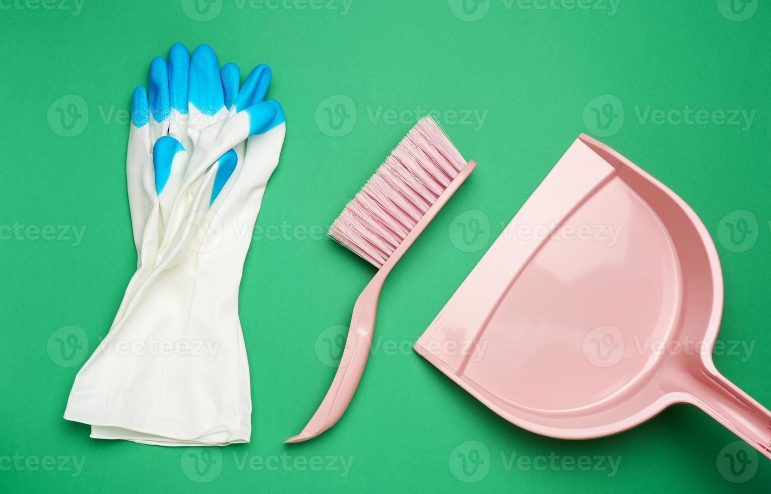 protective white rubber gloves and a pink plastic scoop with a brush photo